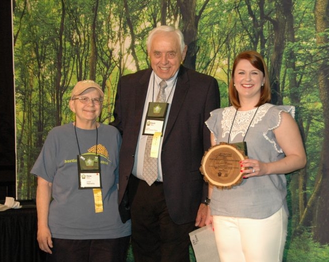 Davy Gibby award with three people holding award